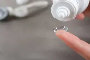 Contact lens on female finger