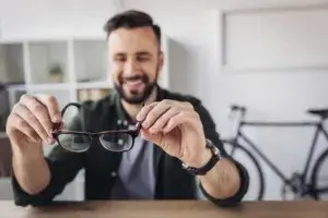 Man holding eyeglasses