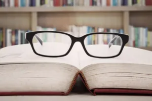 Reading glasses sitting on pages of open book