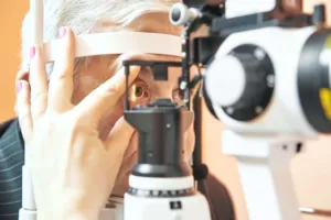 Senior male patient having eye examed at eye doctor appointment