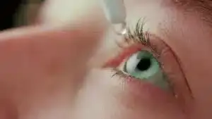 Close-up of person putting eye drops in eye