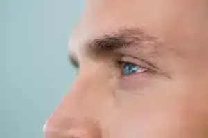 Side profile of face of man, focus on eye