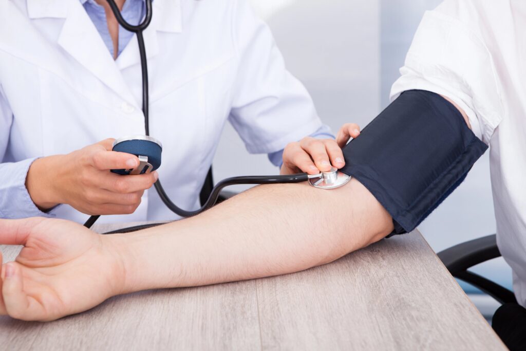 doctor checking patient blood pressure