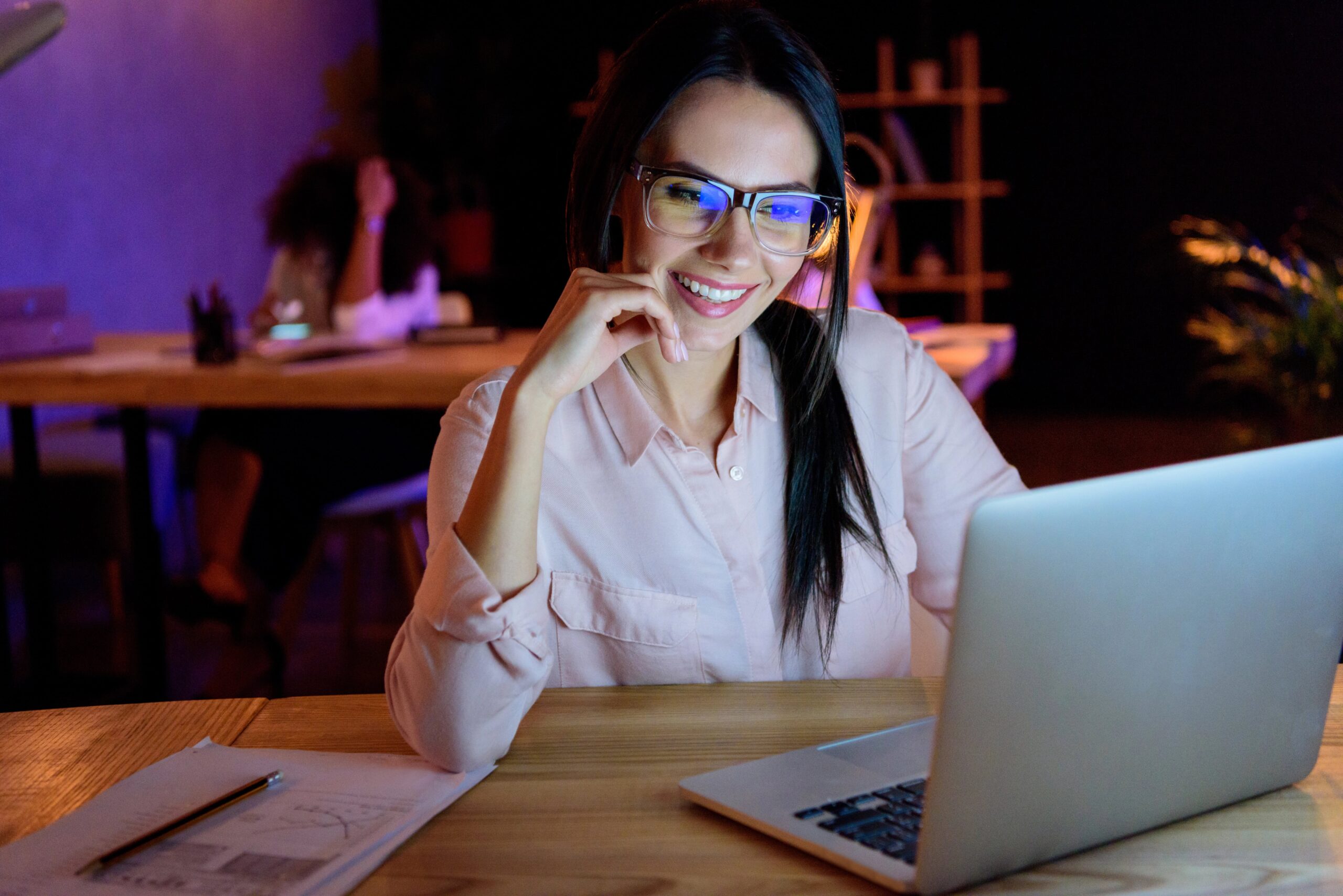Woman wearing glasses looking at laptop