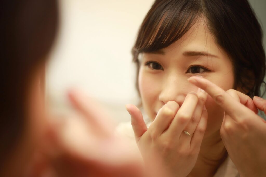 Close-up of woman putting in contact lens